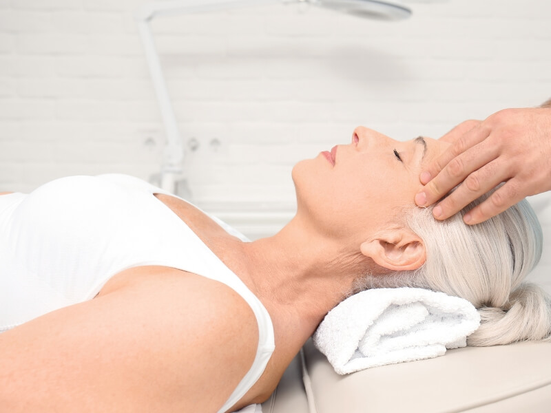 Female receiving a gentle massage specifically tailored for osteoporosis, highlighting the therapeutic and stress-relieving benefits of massage for osteoporosis management
