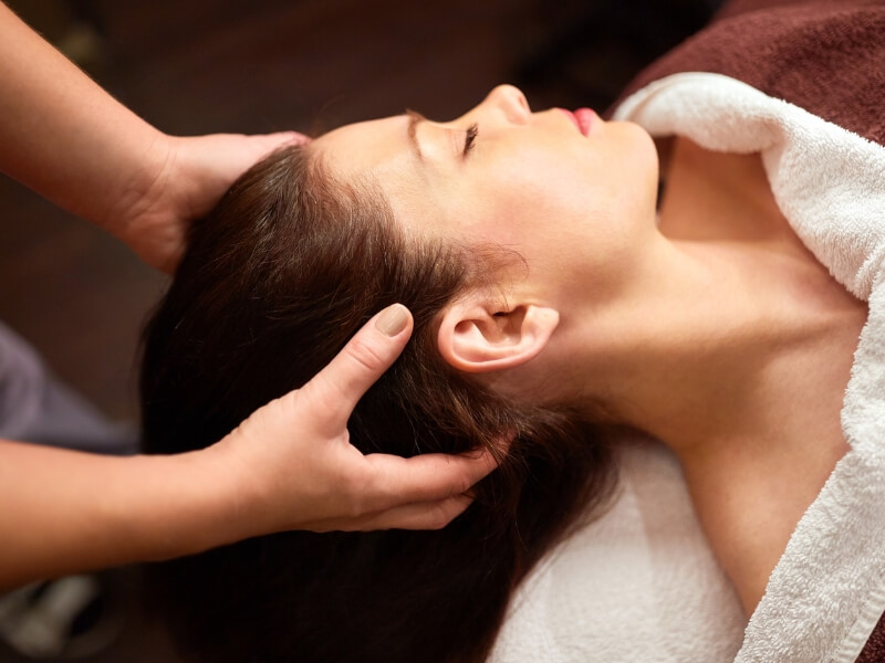 female in relaxed state, experiencing benefits of Indian Head Massage treatment